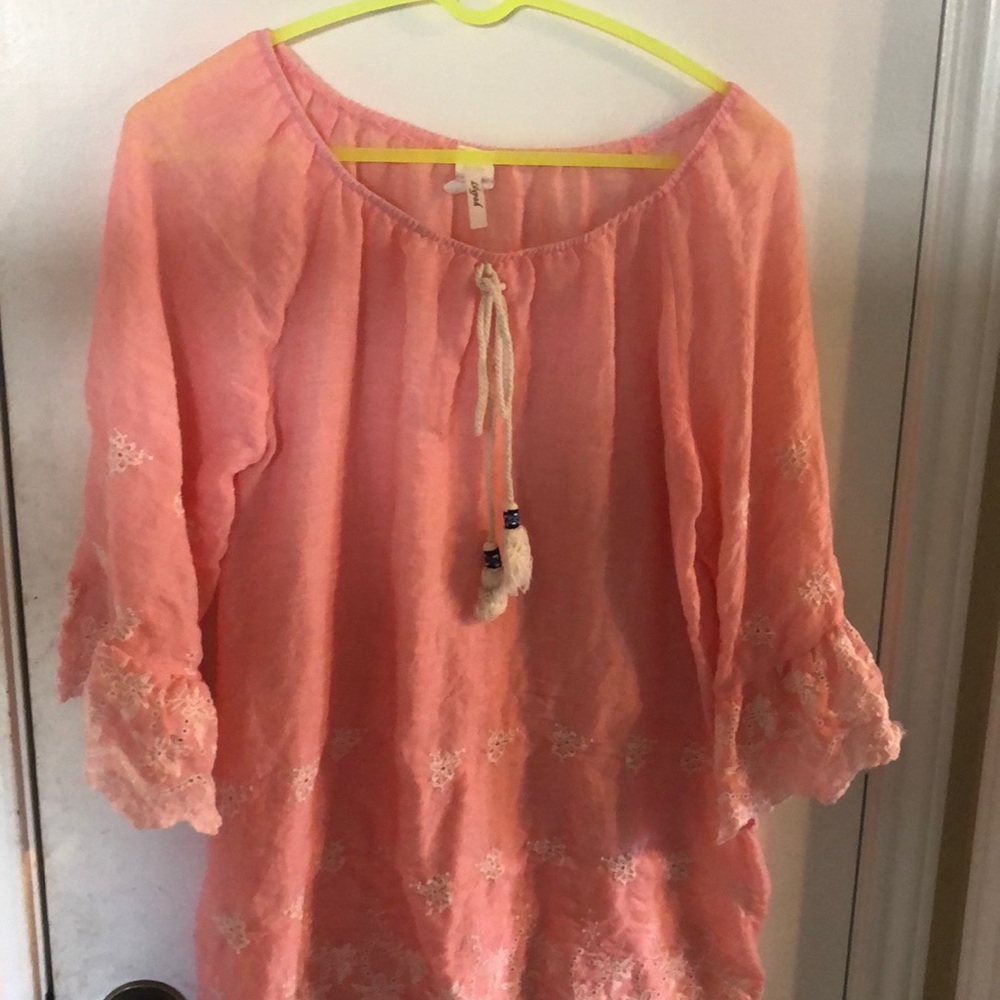 Light pink shirt.